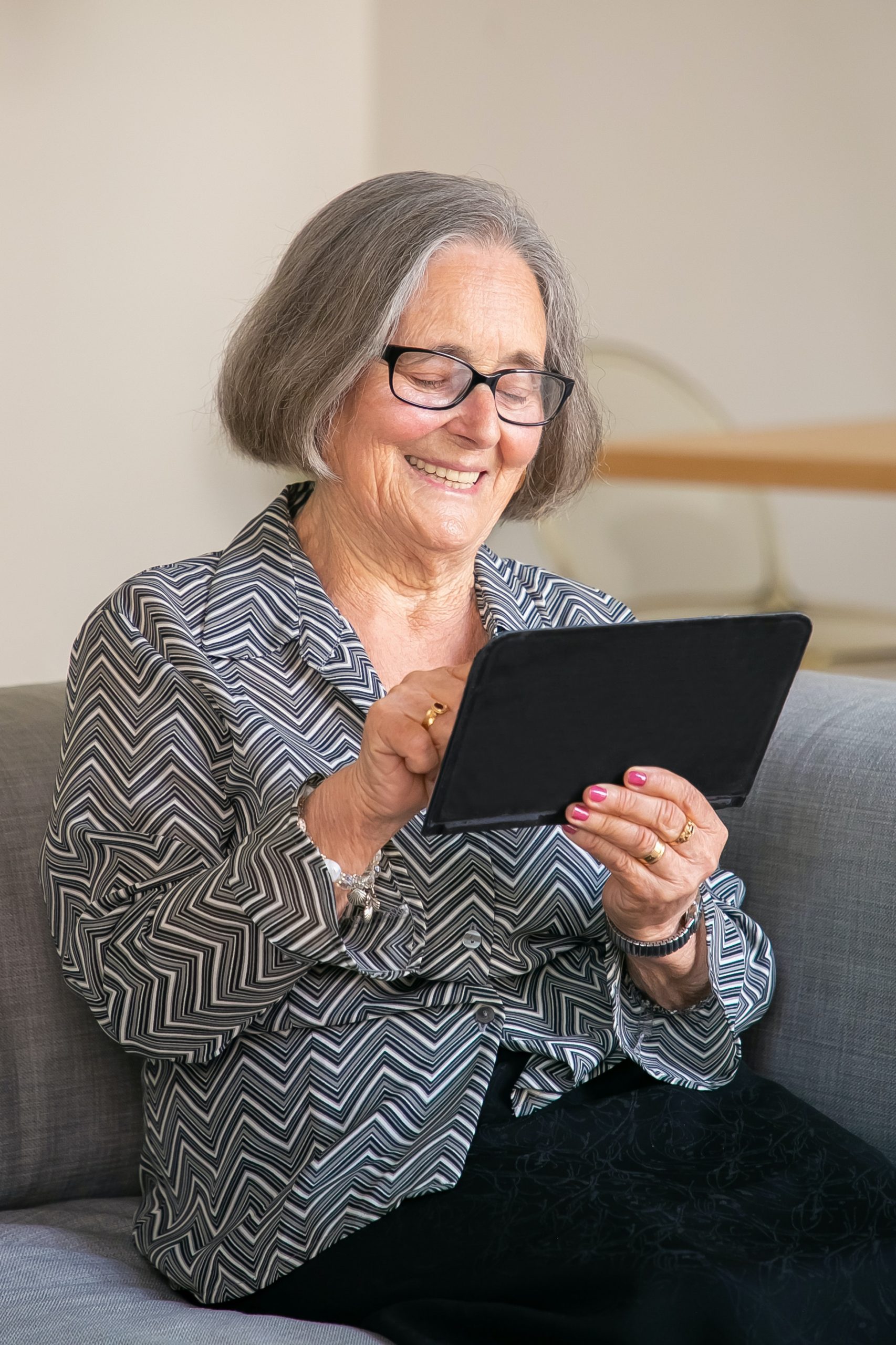 Senior Woman using Ipad to look up Shared Touch Healthcare at Home